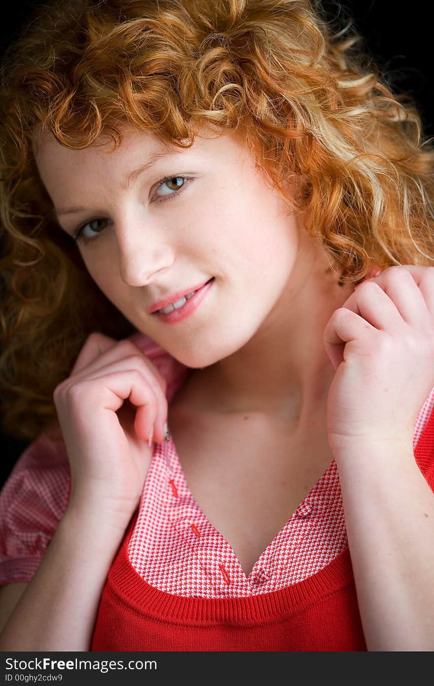 Portrait of a young red-haired woman looking sweetly into the camera. Portrait of a young red-haired woman looking sweetly into the camera