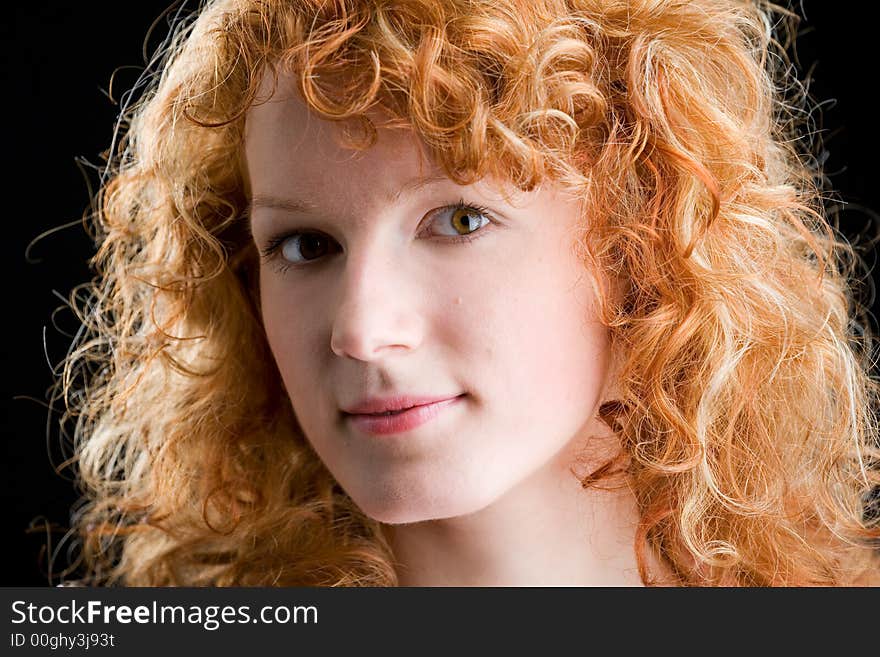 Portrait of a young red-haired woman looking into the camera. Portrait of a young red-haired woman looking into the camera