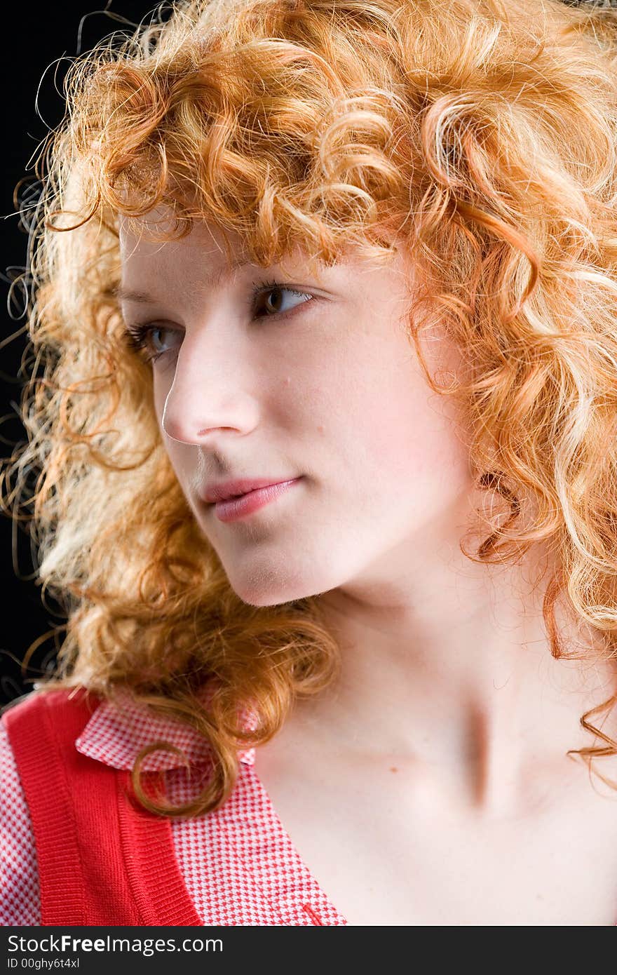 Portrait of a young red-haired woman looking sideways