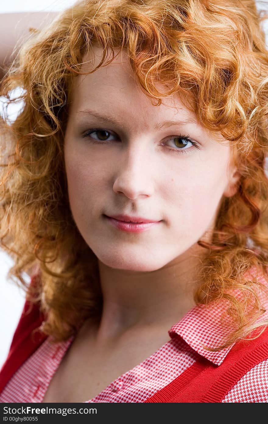 Portrait of a young red-haired woman looking into the camera. Portrait of a young red-haired woman looking into the camera