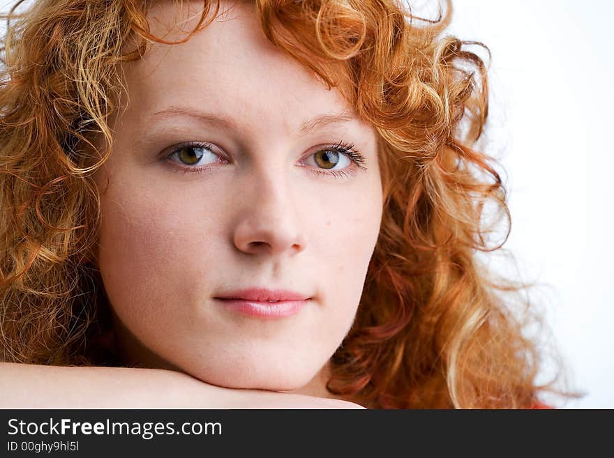 Close-up of a young red-haired woman looking into the camera. Close-up of a young red-haired woman looking into the camera