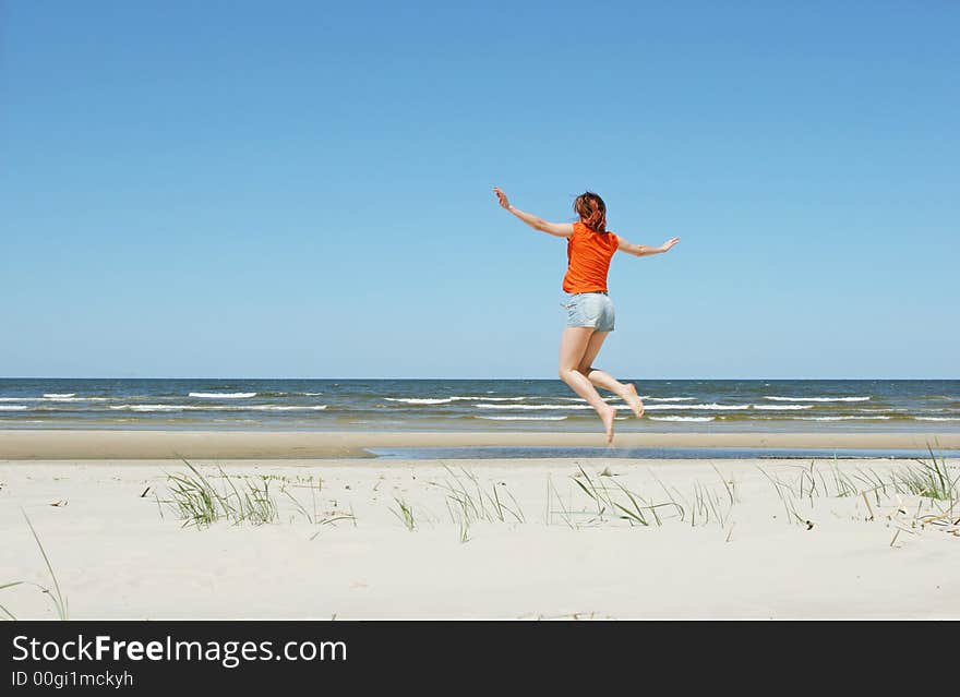 Girl jumping on the beach