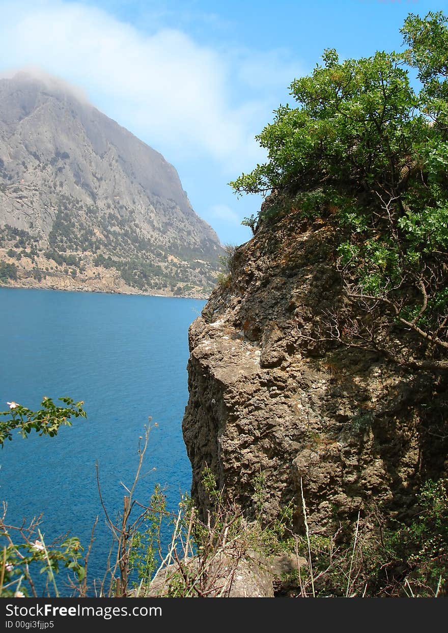 Beautiful landscape (big mountain, blue sea and sky with clouds)