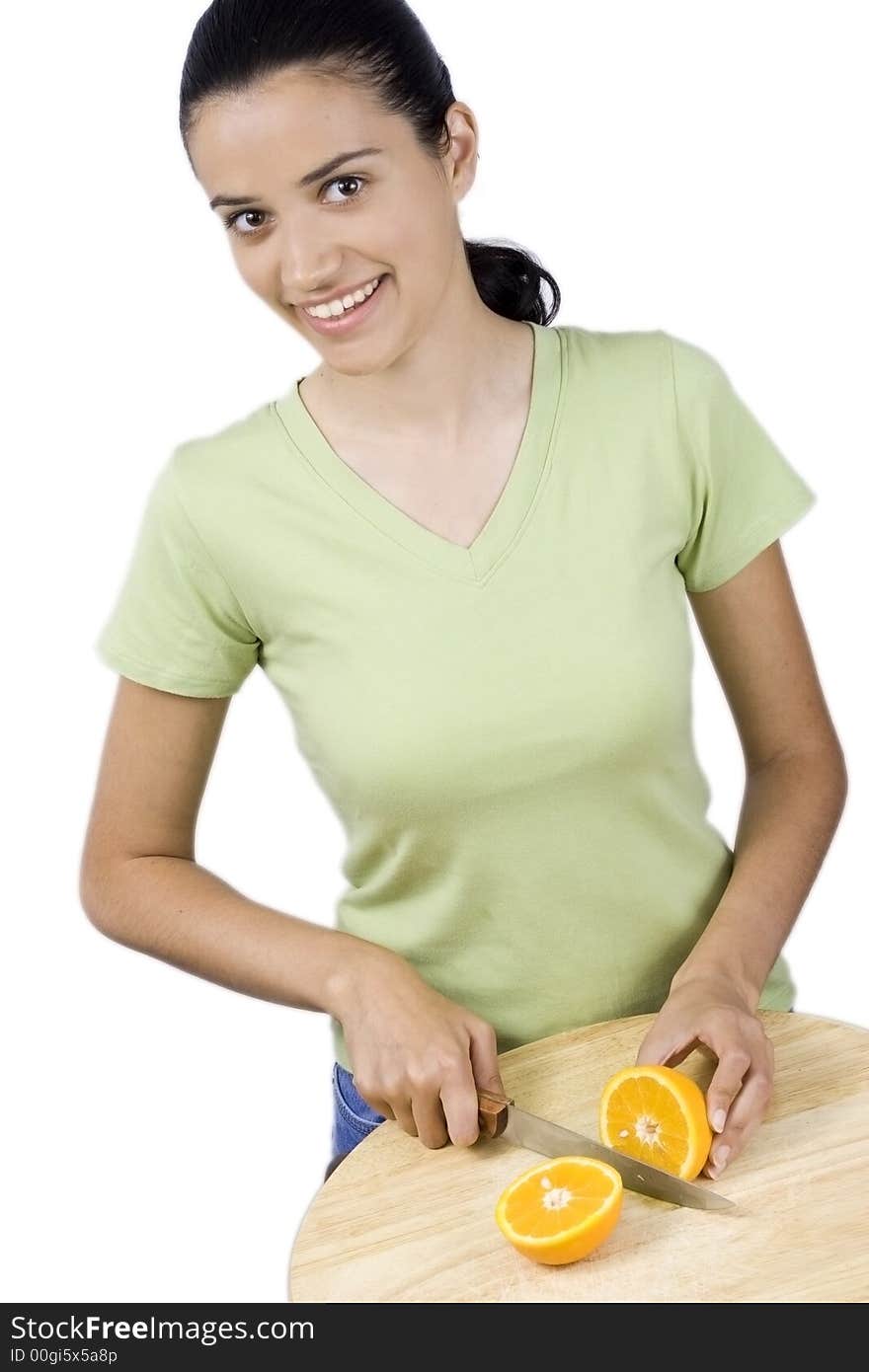 Girl cutting orange with knife