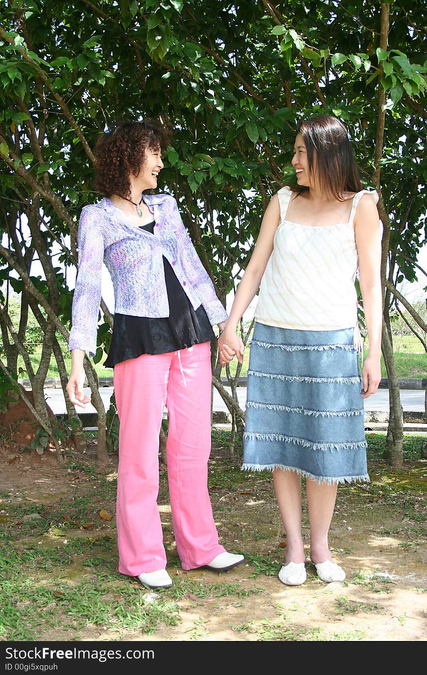 Girls Holding Hand In The Park