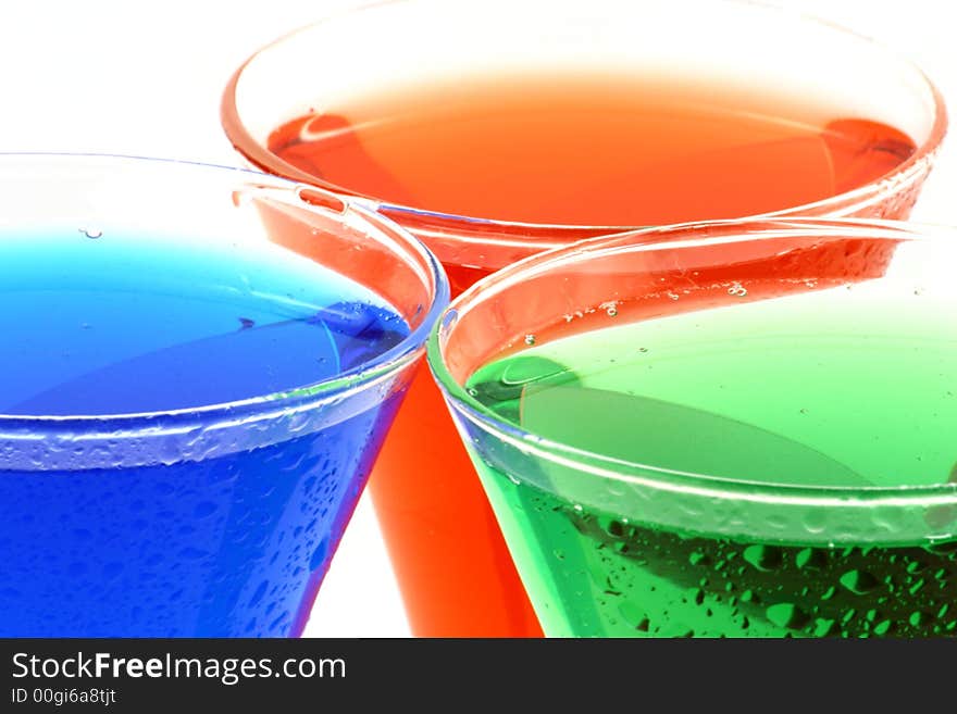 View at different colour liquids in a glasses on a white background. View at different colour liquids in a glasses on a white background