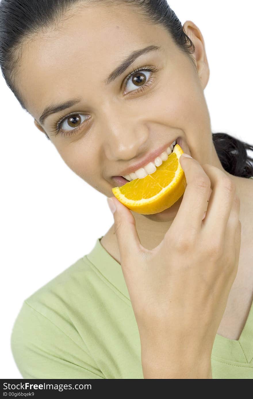 Smiling girl eating piece of orange. Smiling girl eating piece of orange