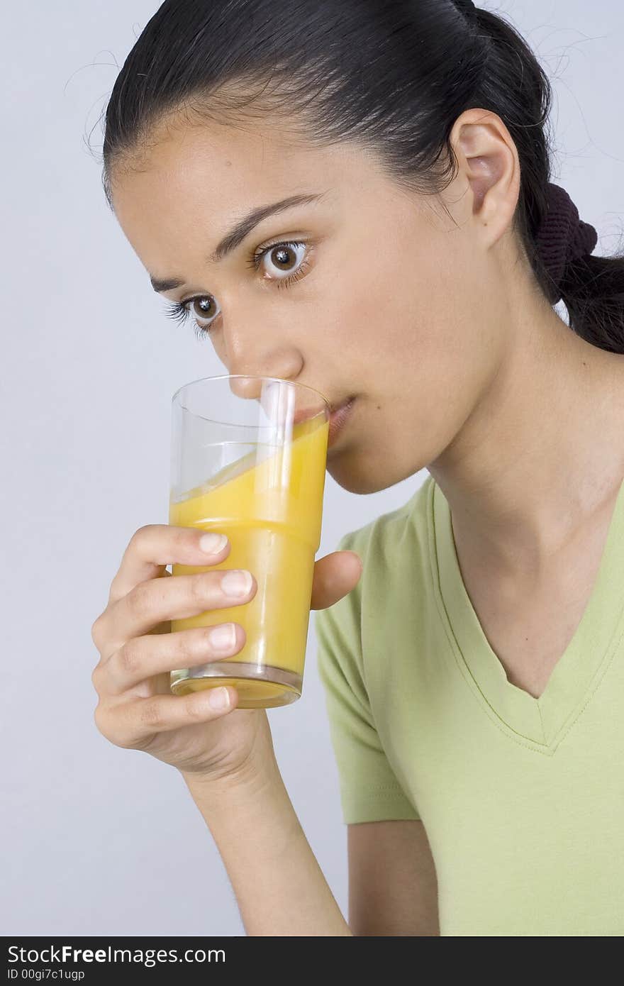 Girl holding glass with juice and drinking. Girl holding glass with juice and drinking