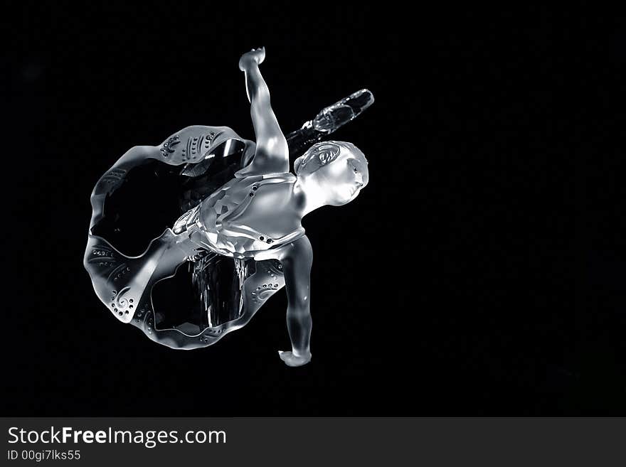 A crystal ballerina dancing on a black background