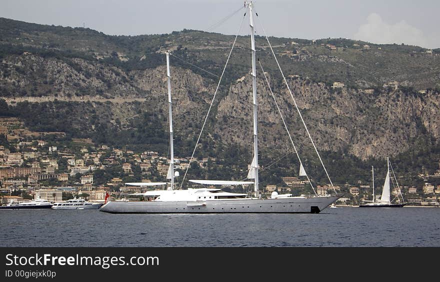 Sailing yachts and motor yachts getting underway in a bay in France. Sailing yachts and motor yachts getting underway in a bay in France