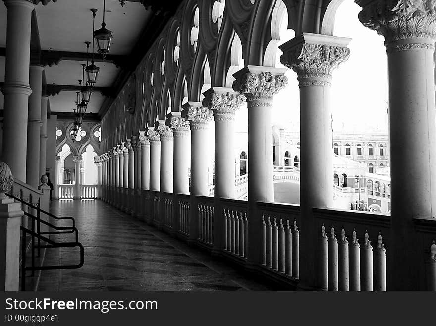 Black and white of a breezeway entrance to a very fancy hotel.