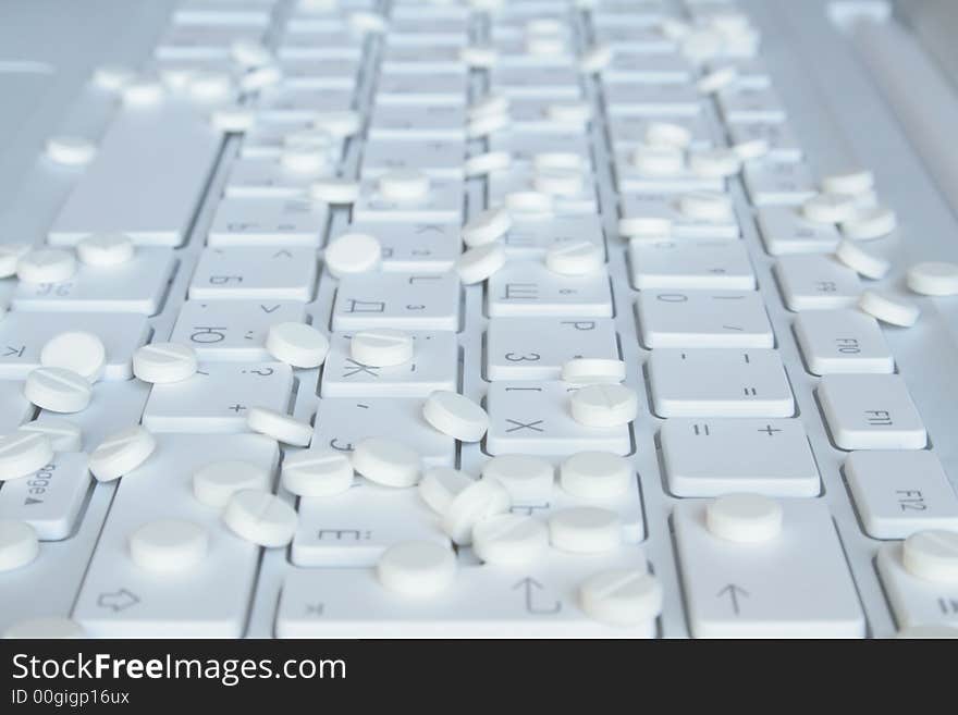 Tablets on the white notebook keyboard. Tablets on the white notebook keyboard