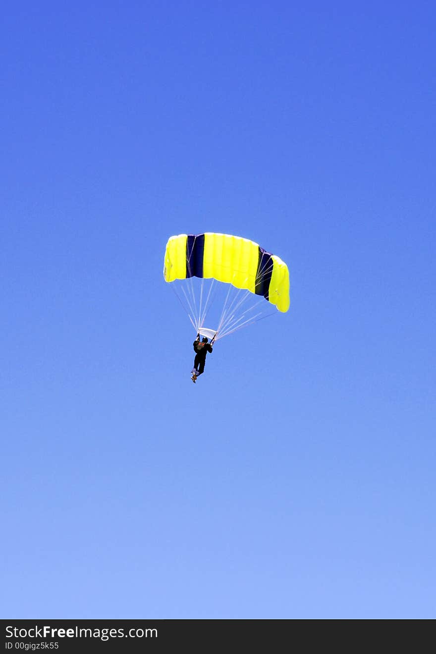 Yellow and black parachute and a man. Yellow and black parachute and a man.