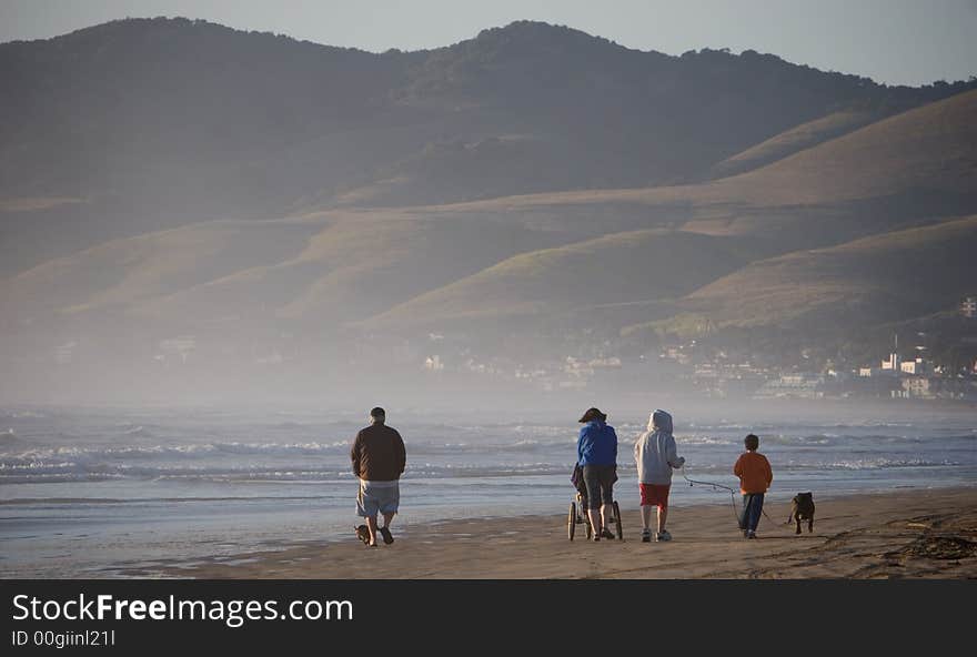 Family walking on ocean beach. Family walking on ocean beach.