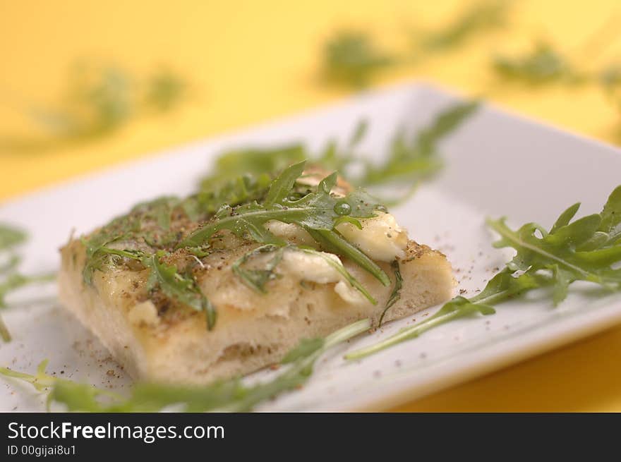 proud pizza with herbs and cheese on the yellow background