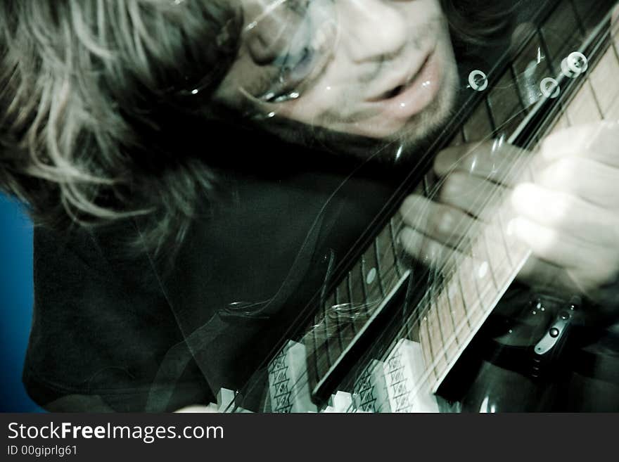 Rocker playing electric guitar, zoom and strobe lighting. Rocker playing electric guitar, zoom and strobe lighting.