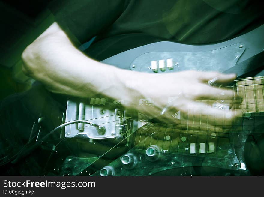 Hand in motion on electric guitar, strobe lighting. Hand in motion on electric guitar, strobe lighting