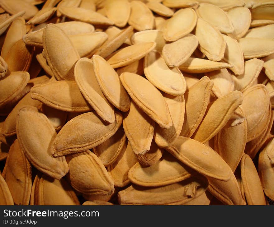 Close up of un-roasted pumpkin seeds.