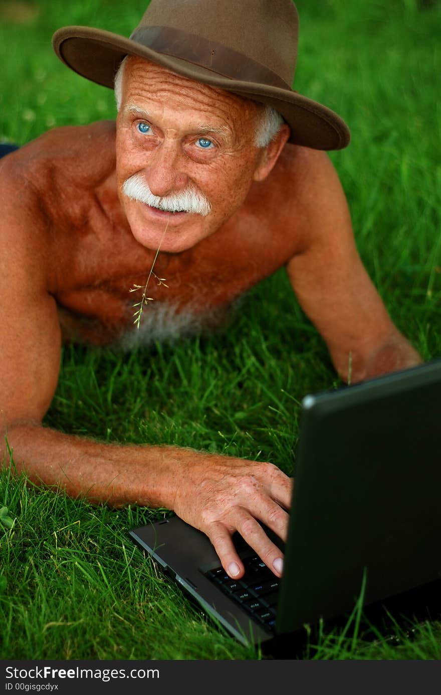 Handsome senior man with computer