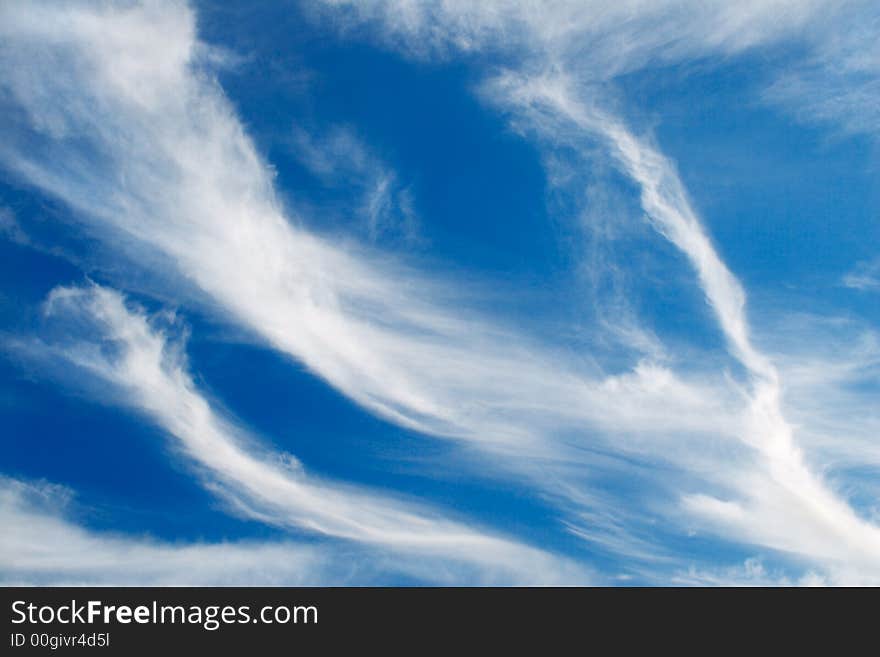 Feather-like clouds in the blue sky. Feather-like clouds in the blue sky