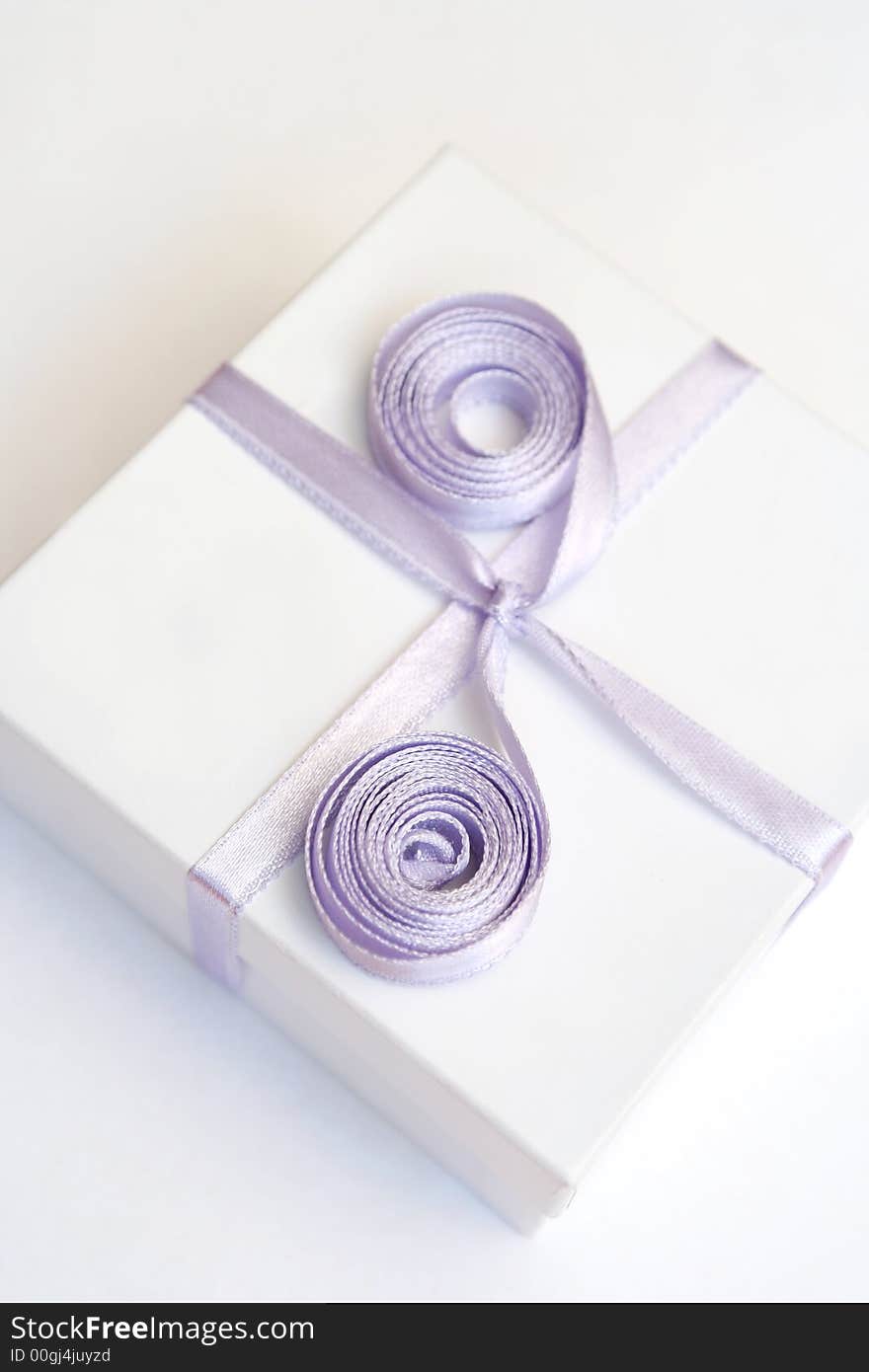 Gift in a white box with a lilac tape