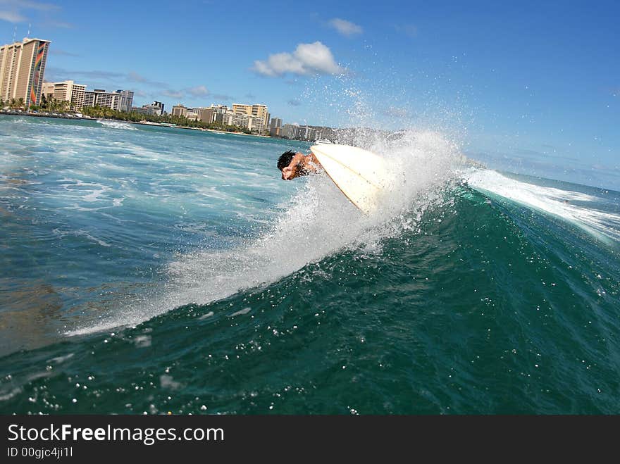 A shortboard surfer surfing on a beautiful wave in hawaii. A shortboard surfer surfing on a beautiful wave in hawaii