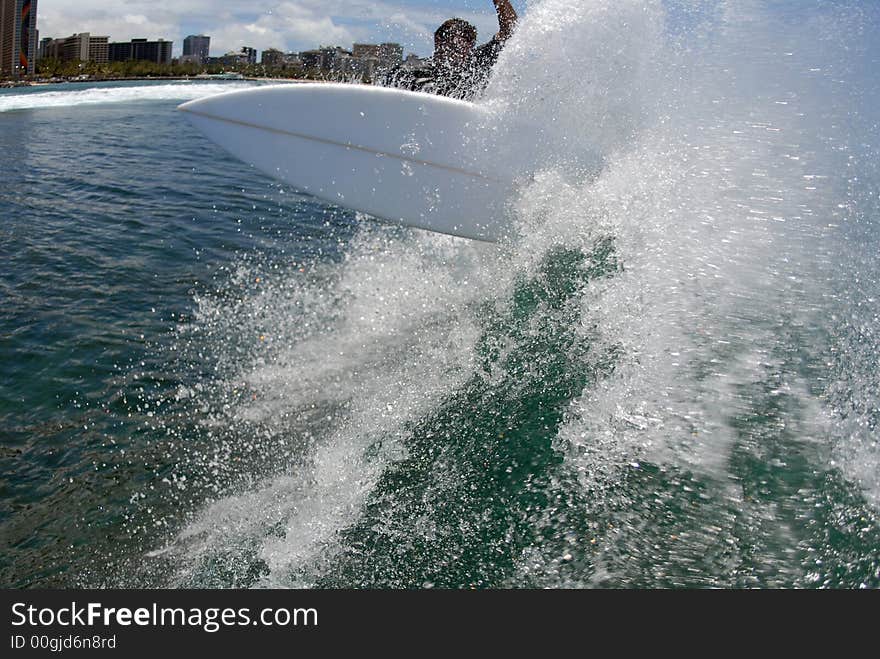 A shortboard surfer surfing on a beautiful wave in hawaii. A shortboard surfer surfing on a beautiful wave in hawaii