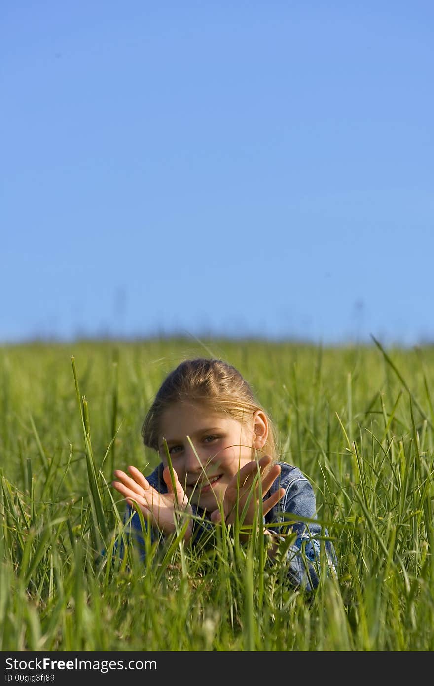 The girl lays on a grass. The girl lays on a grass