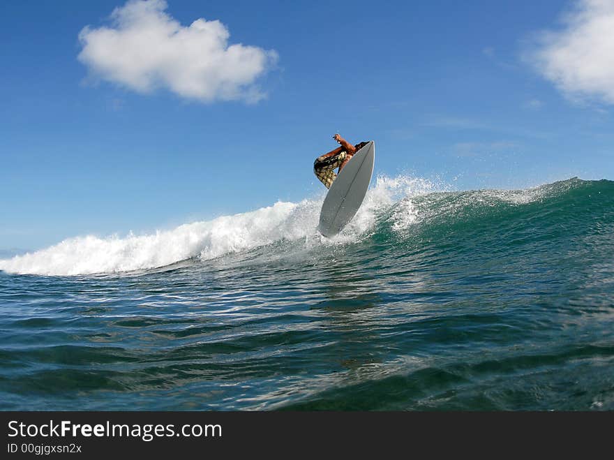 A surfer doing a chop hop air. A surfer doing a chop hop air.