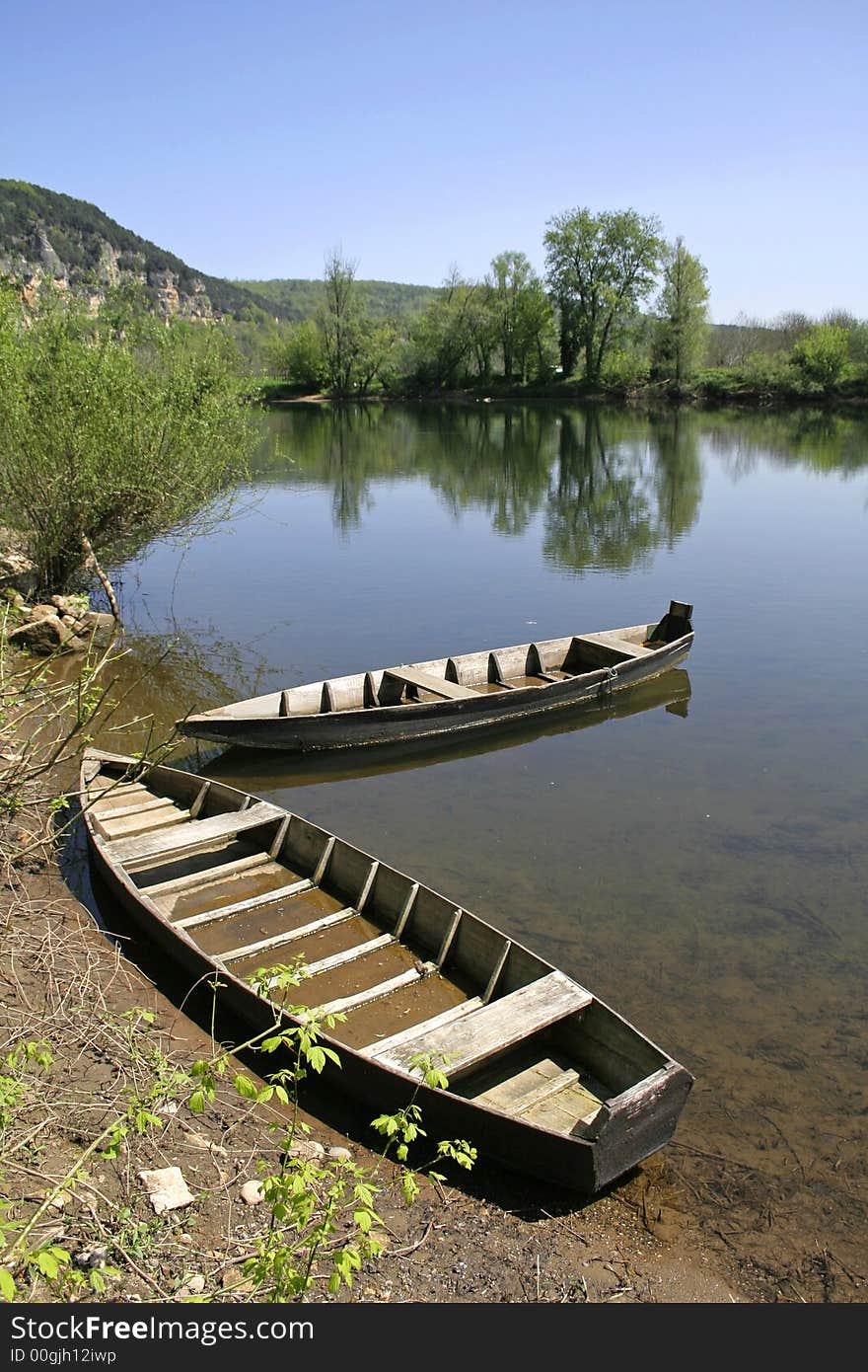 Two rowing boats moored on the riverbank