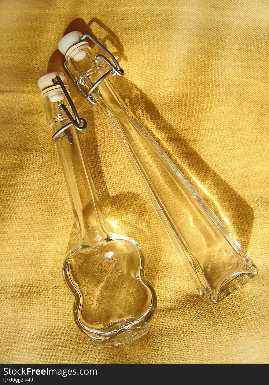 Bottles of glass with yellow reflection