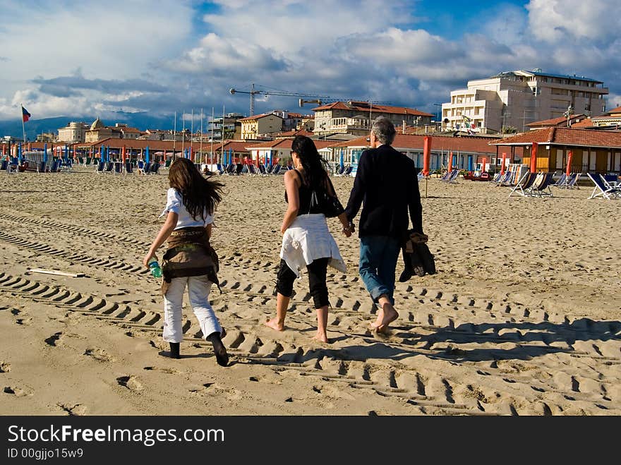 Happy family has a stroll on the beach. Happy family has a stroll on the beach