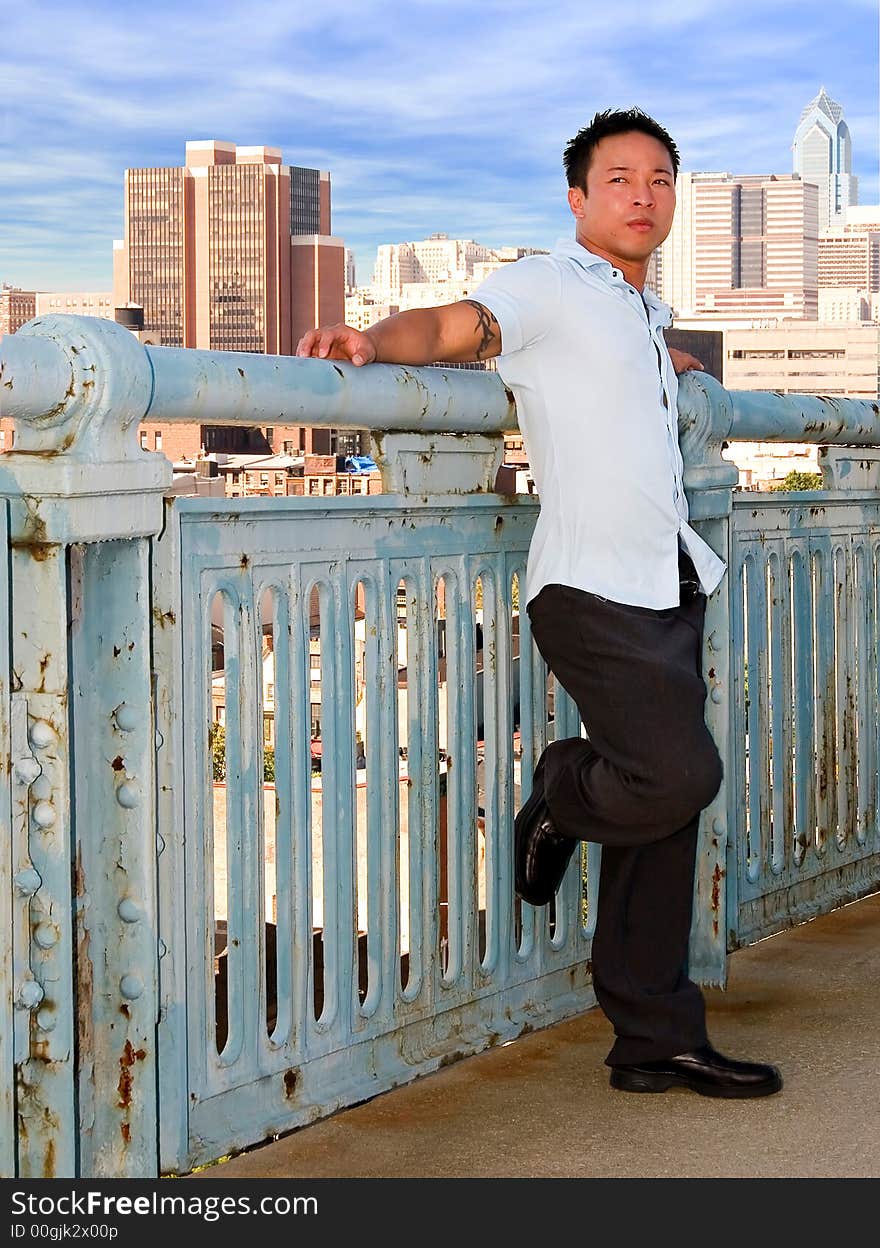 A young successful man overlooking the big city. A young successful man overlooking the big city