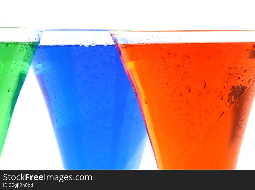 Colourful drinks in red green and blue standing together. Colourful drinks in red green and blue standing together