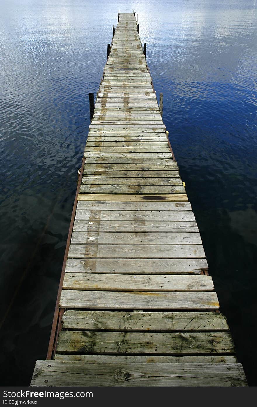 Dock floating in blue lake. Dock floating in blue lake