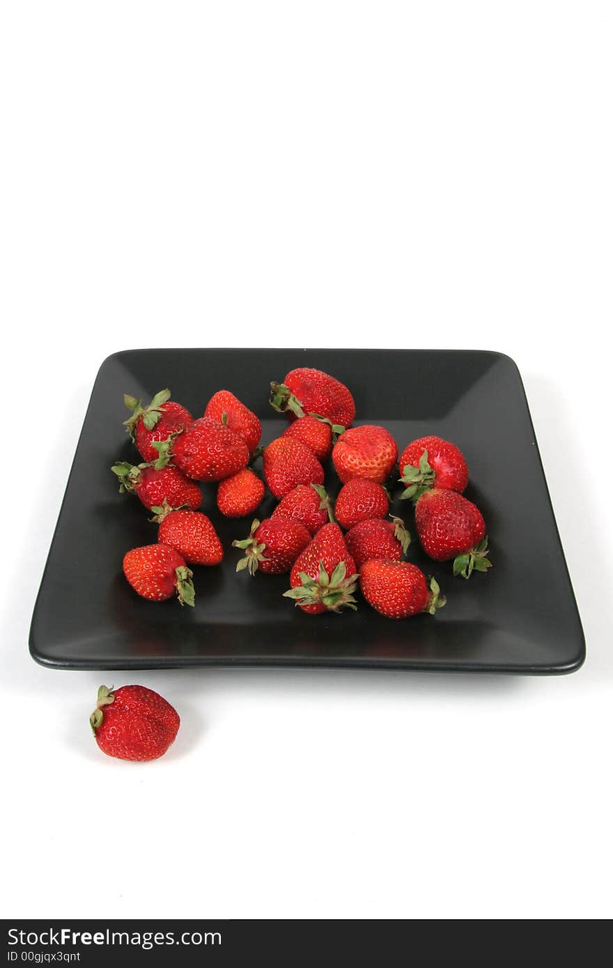 Strawberries on Black Plate over White