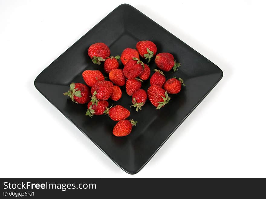 Strawberries on Black Plate over White