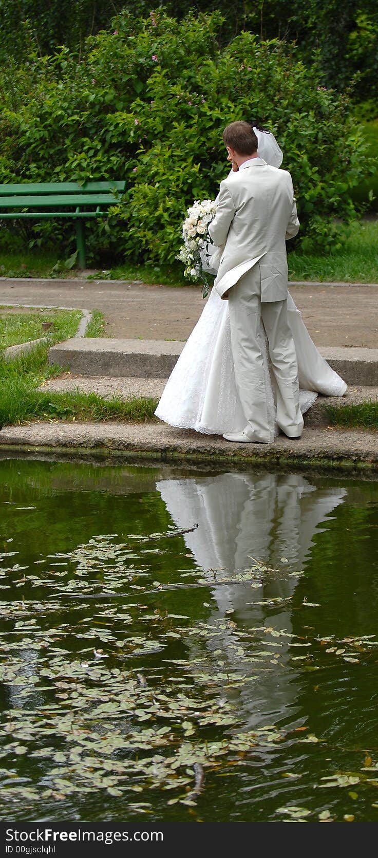 The groom with the bride stand on coast of the river. The groom with the bride stand on coast of the river