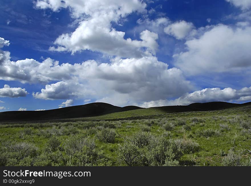 Landscape view of countryside with green hills blue sky and clouds. Landscape view of countryside with green hills blue sky and clouds