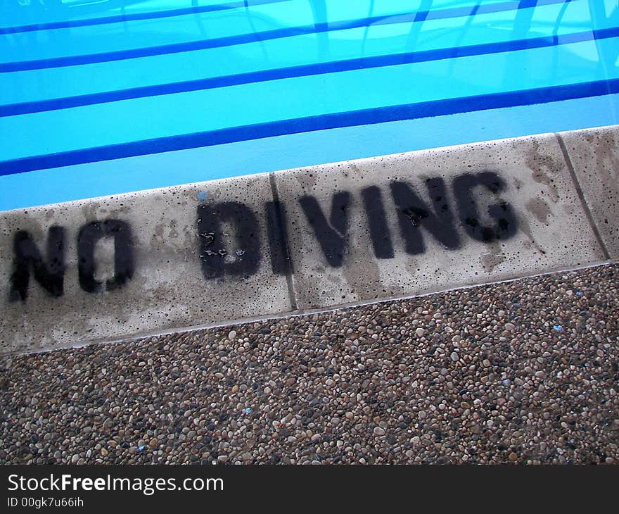 Warning sign on the shallow end of pool