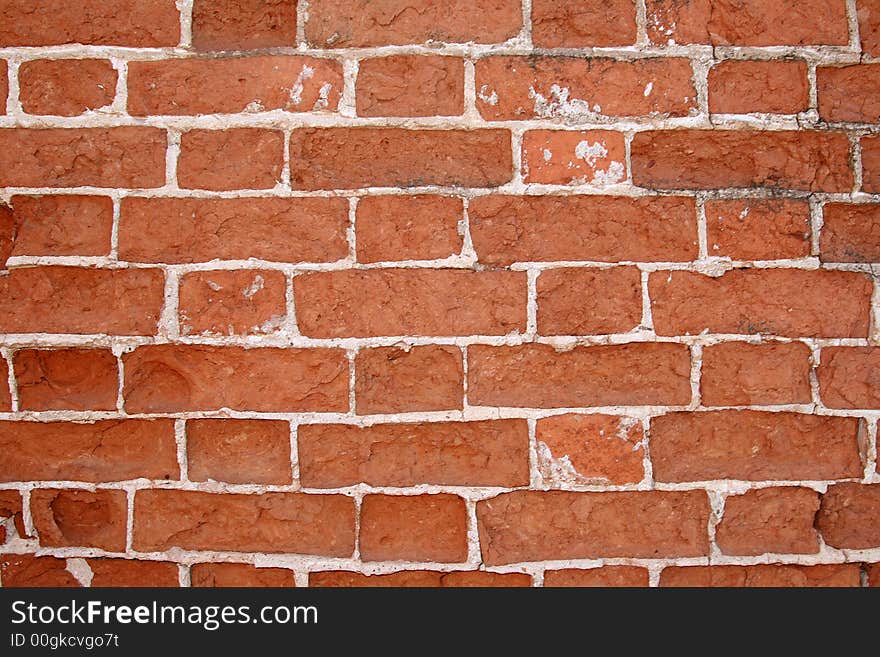 Old, destroyed by time and a rain, a brick wall