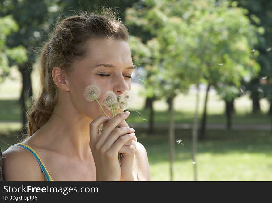 The girl and a dandelion. The girl and a dandelion