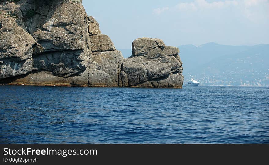 Yacht Behind Rocks