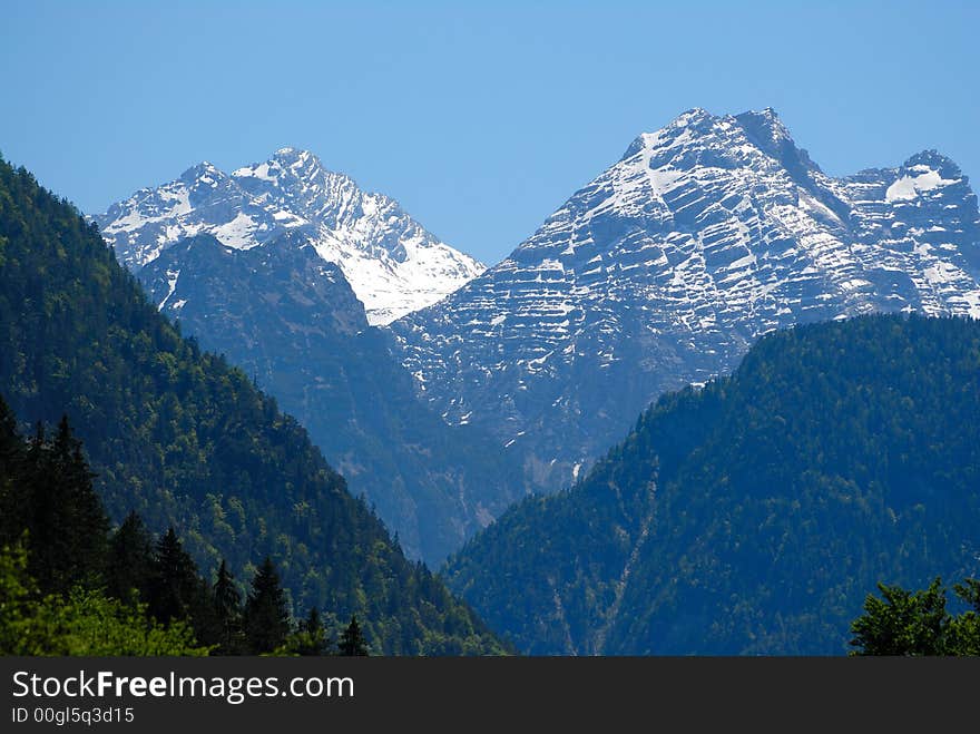 Two snow Alps peaks on the sky background. Two snow Alps peaks on the sky background