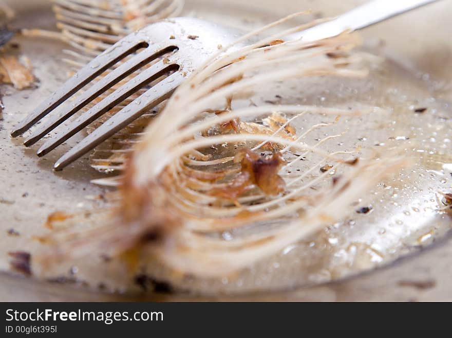 Fishbones on  plate, near forks