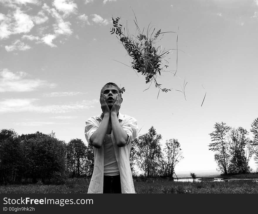 The boy throws flowers on coast of Baikal. The boy throws flowers on coast of Baikal