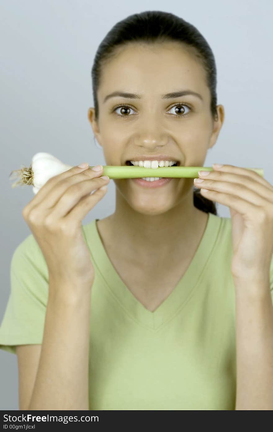 Girl holding garlic in her mouth. Girl holding garlic in her mouth