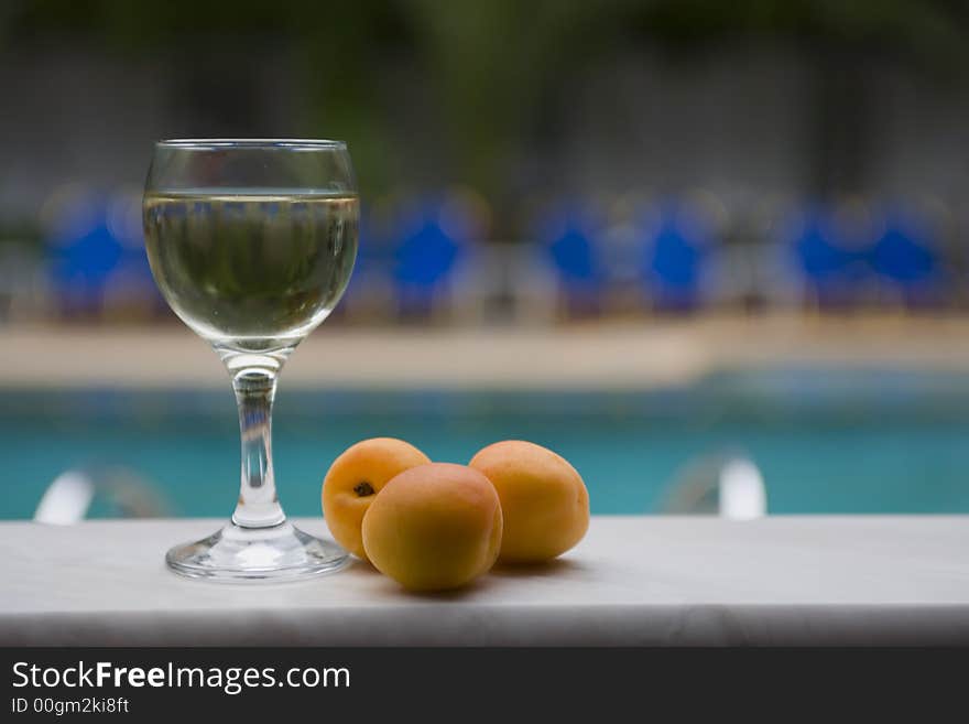 Glass of wine with peaches, crystal, aroma