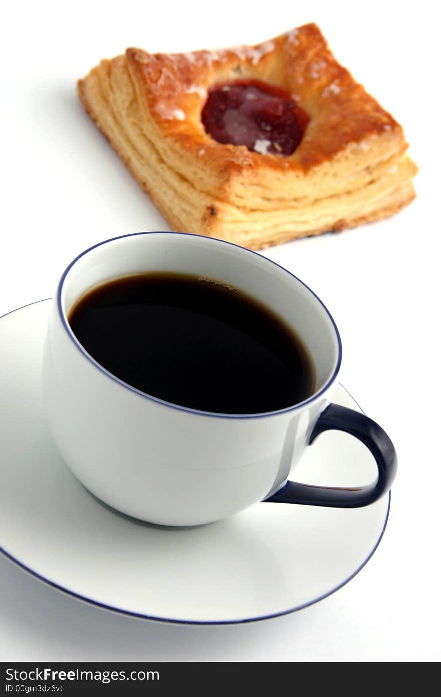 Coffee and a bun on white background