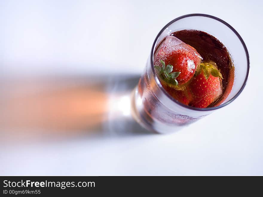 Strawberry and ice cubes in a glass. Strawberry and ice cubes in a glass